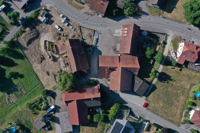 Die Gebäudegruppe Steinhof im Ortsteil Wil (Gemeinde Mettauertal). Im Hintergrund erkennt man in der Wiese die Terrassierungen des ehemaligen Steinbruchs. Foto: Kantonsarchäologie, © Kanton Aargau